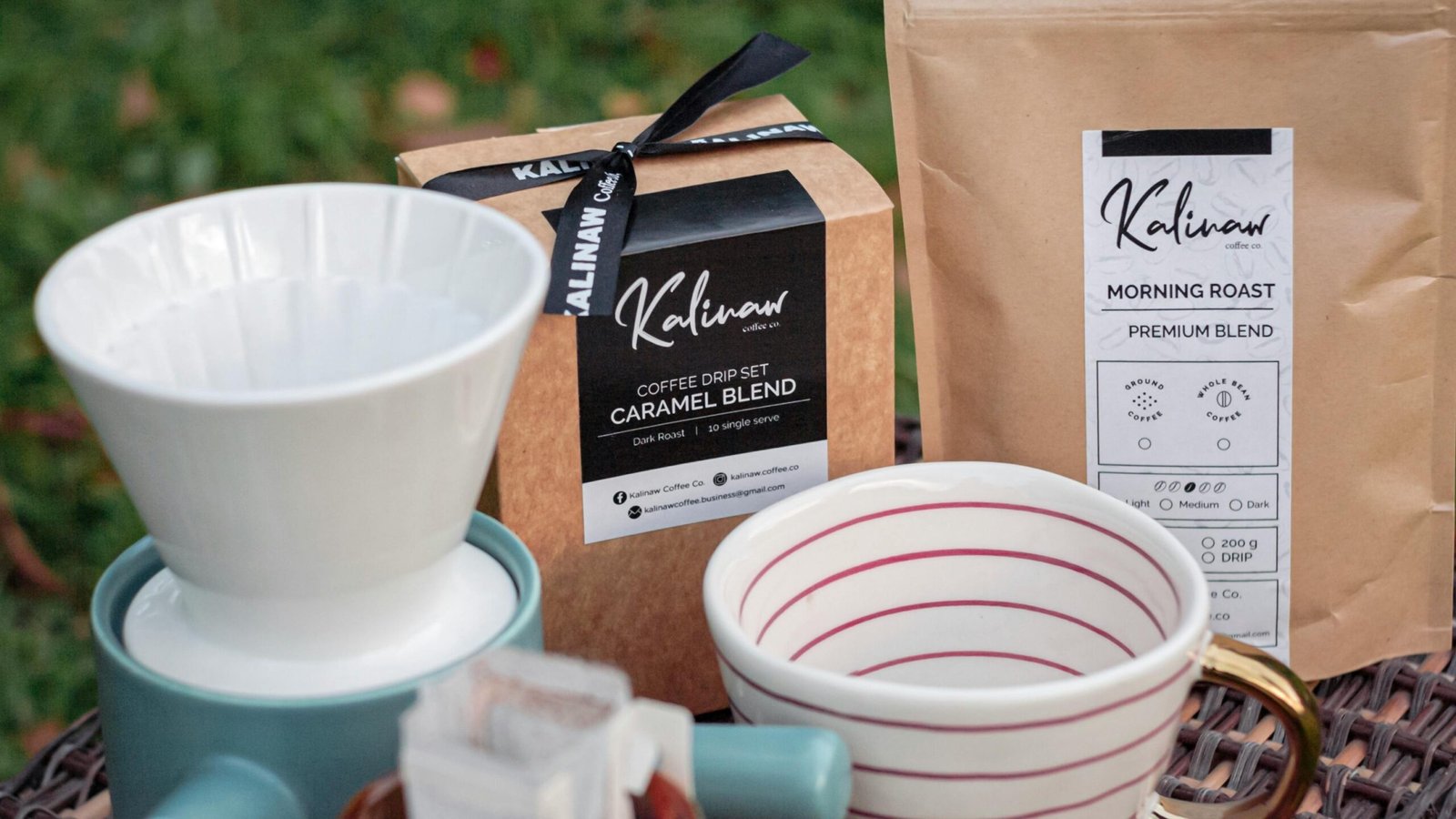Close-up of a coffee drip set and packaging with Kalinaw branding outdoors.